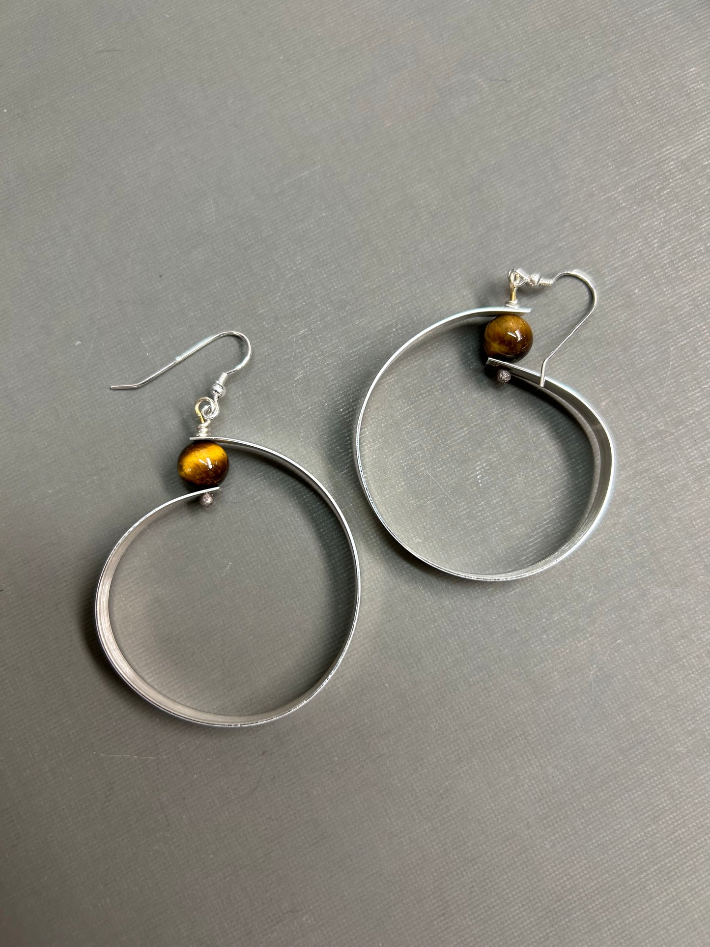 Wide silver hoops and gemstone earrings