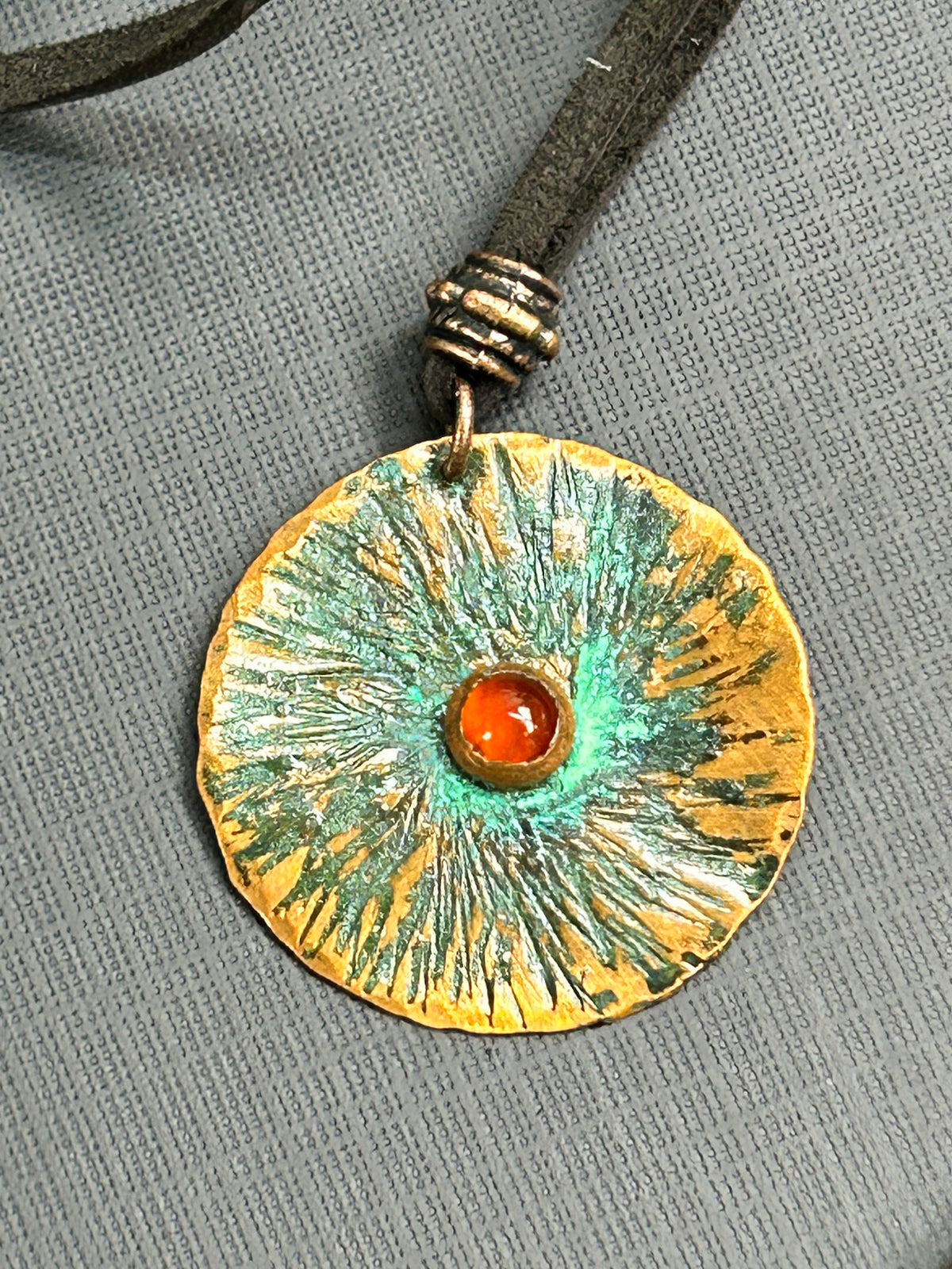 Copper and carnelian pendant on leather