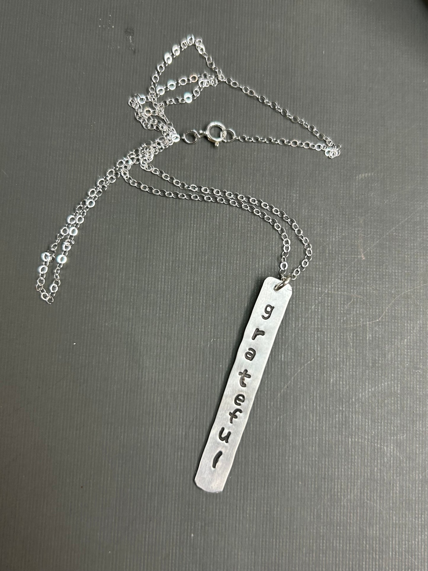 Grateful- stamped silver necklace