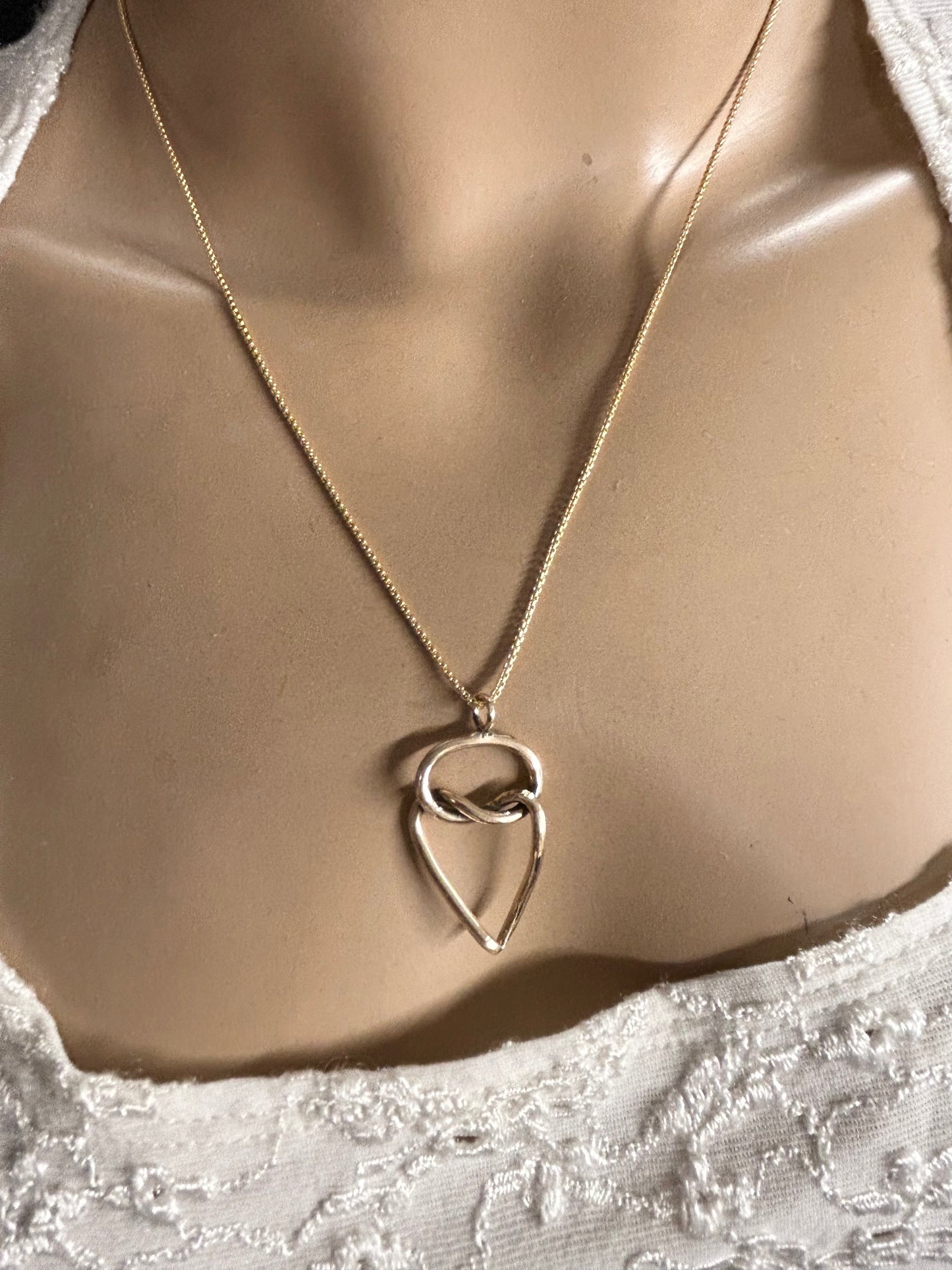 Heart and knot gold necklace