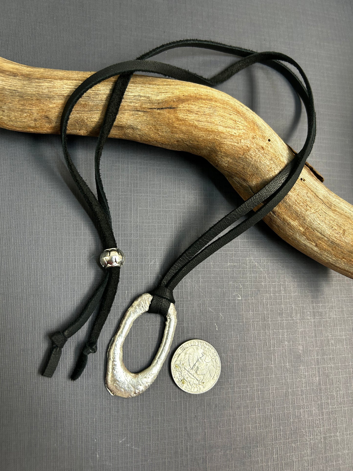 Recycled silver pendant on leather