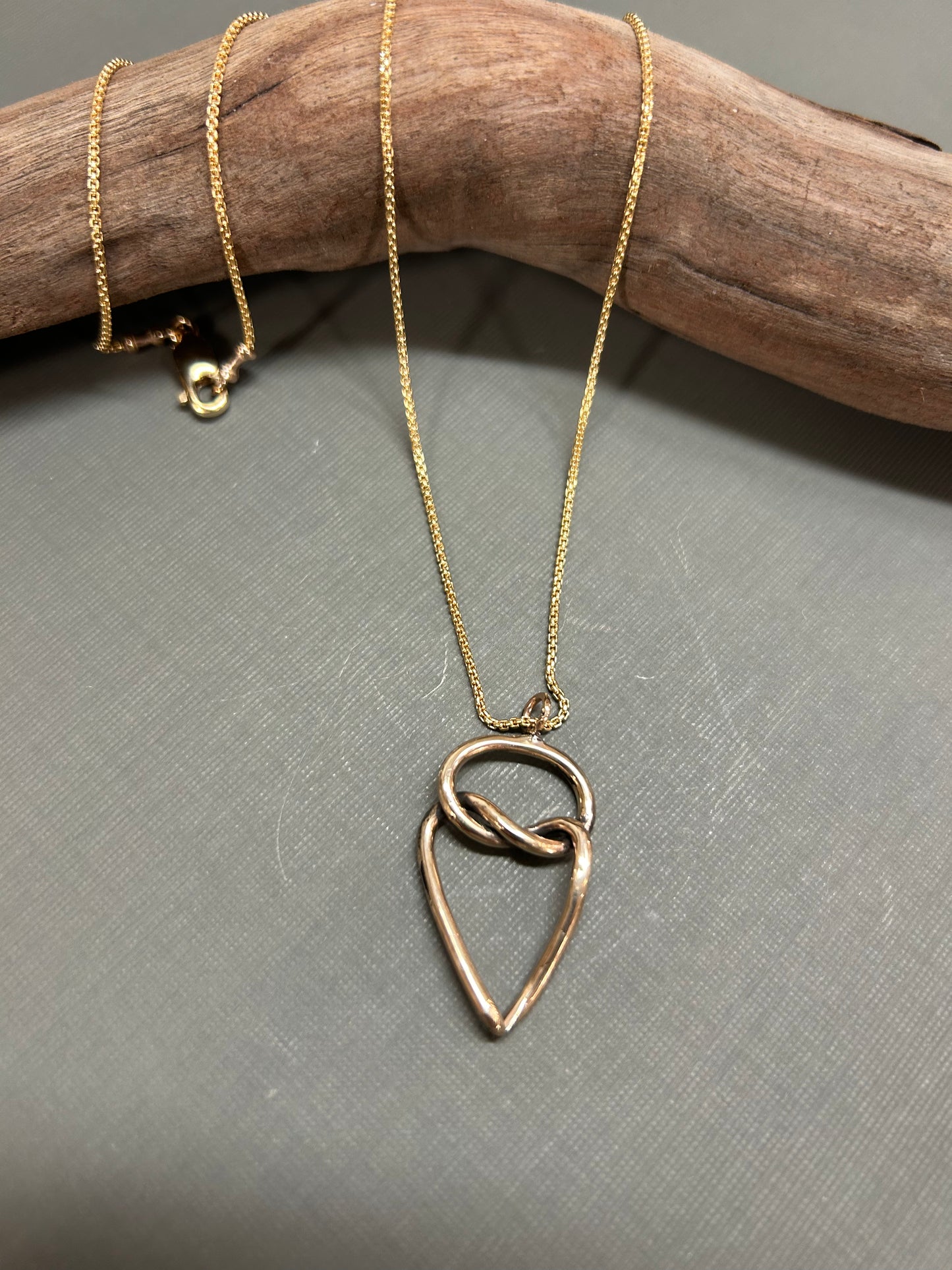 Heart and knot gold necklace