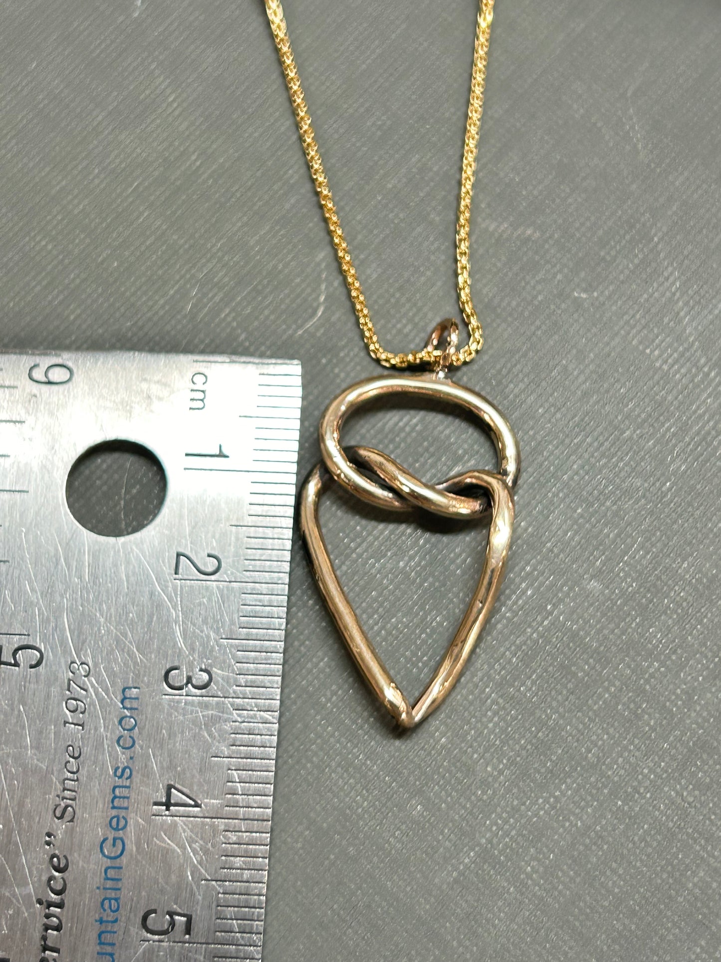 Heart and knot gold necklace