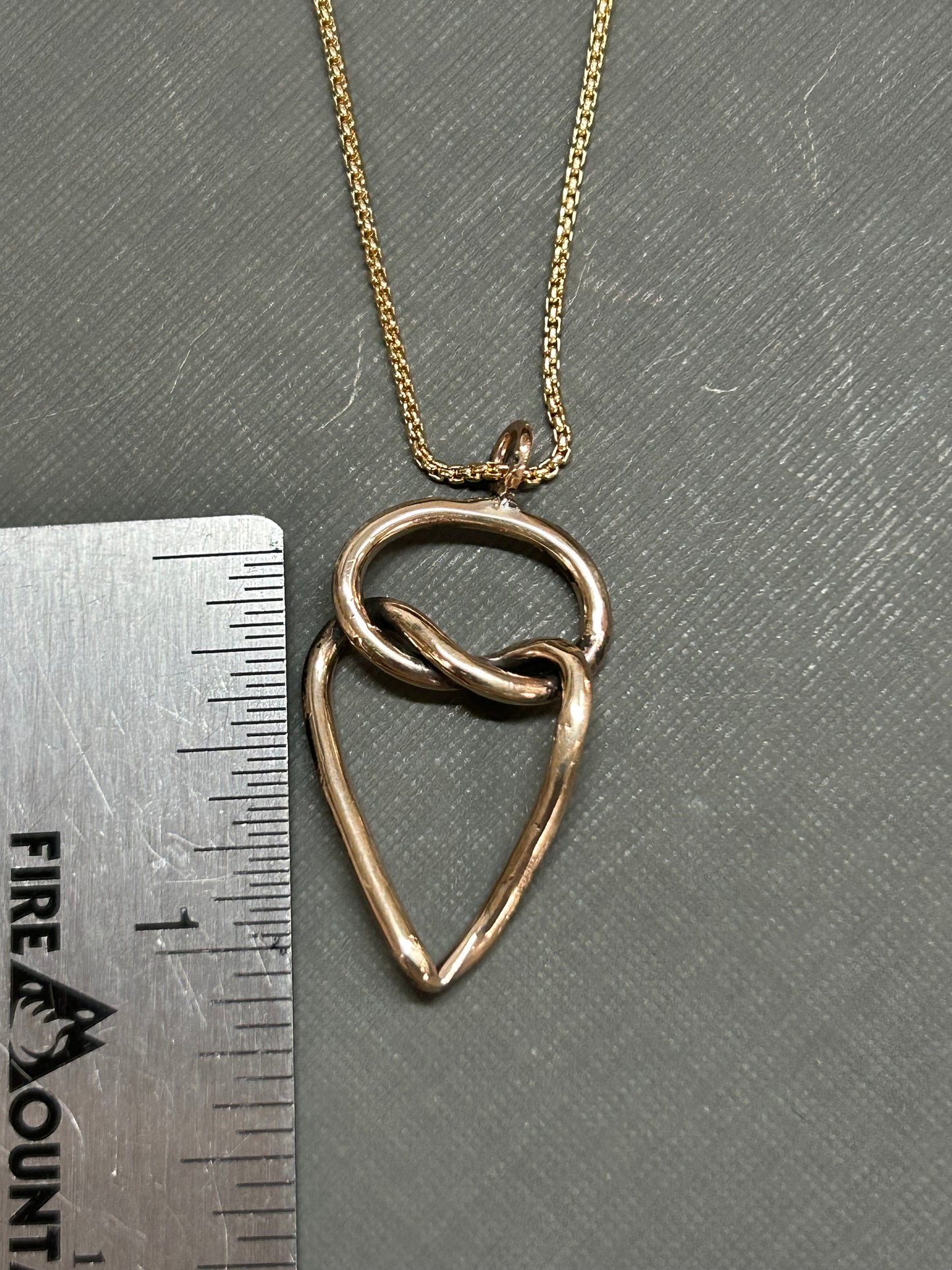 Heart and knot gold necklace