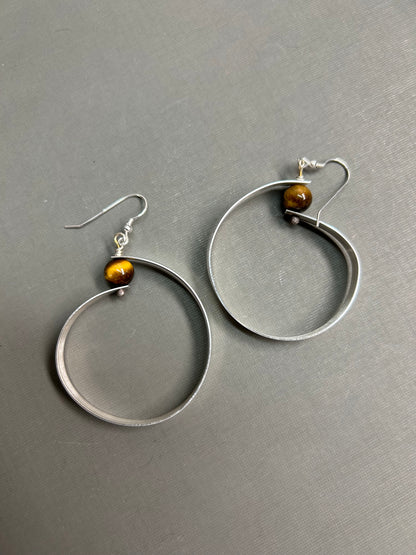 Wide silver hoops and gemstone earrings