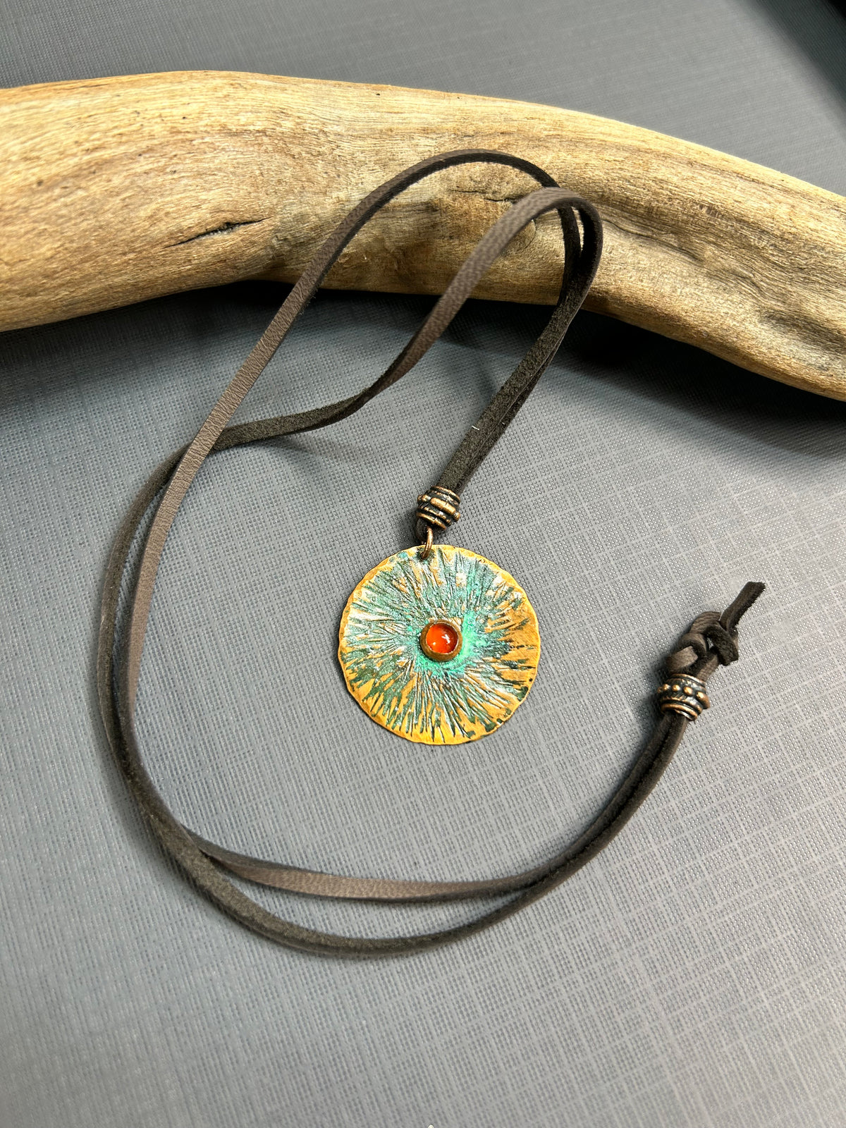 Copper  and carnelian pendant on leather