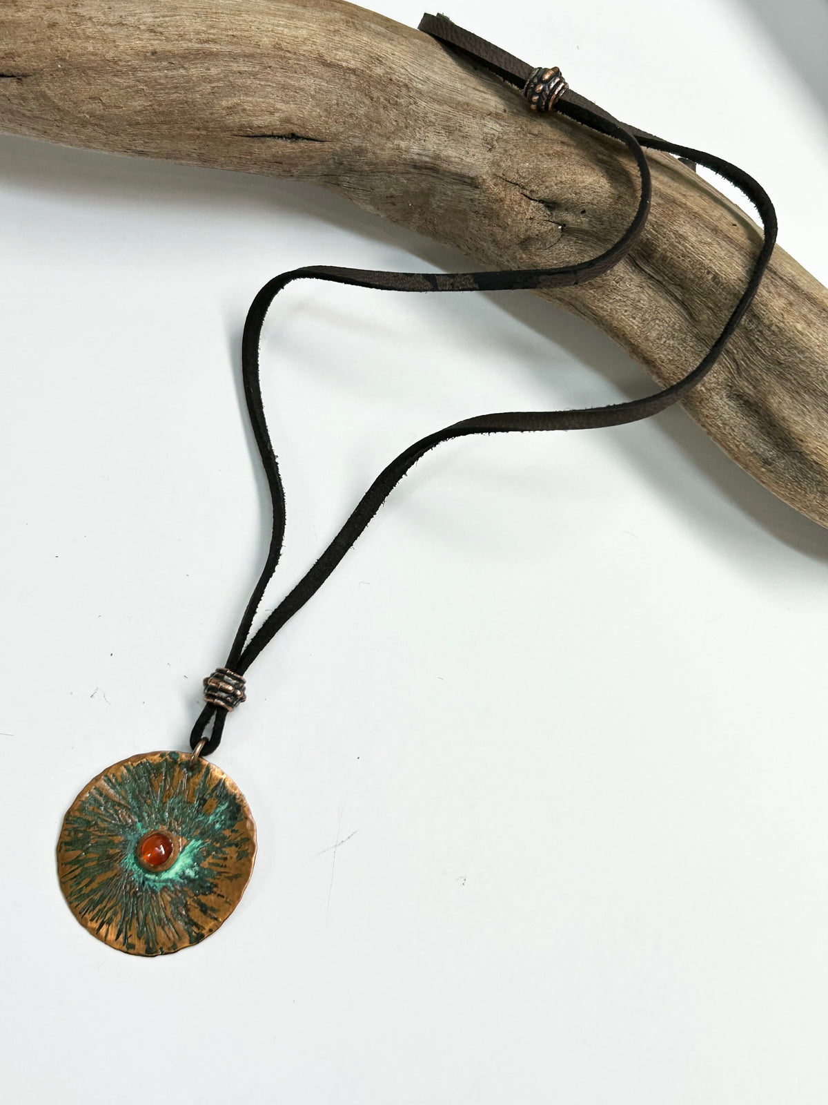 Copper  and carnelian pendant on leather