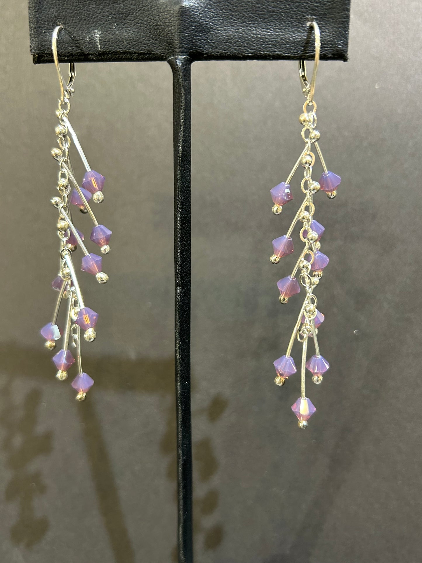 Kinetic earrings silver and purple crystals.