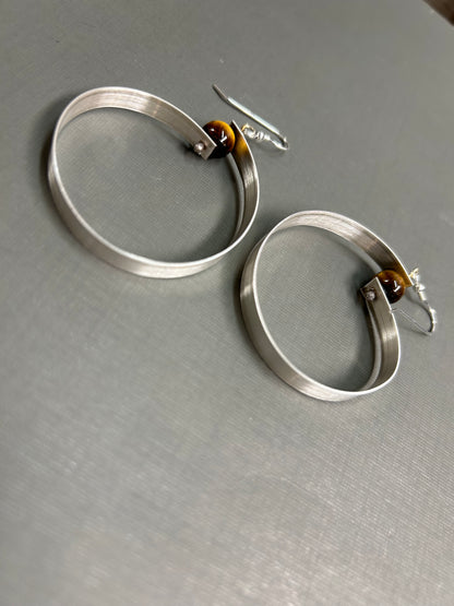 Wide silver hoops and gemstone earrings
