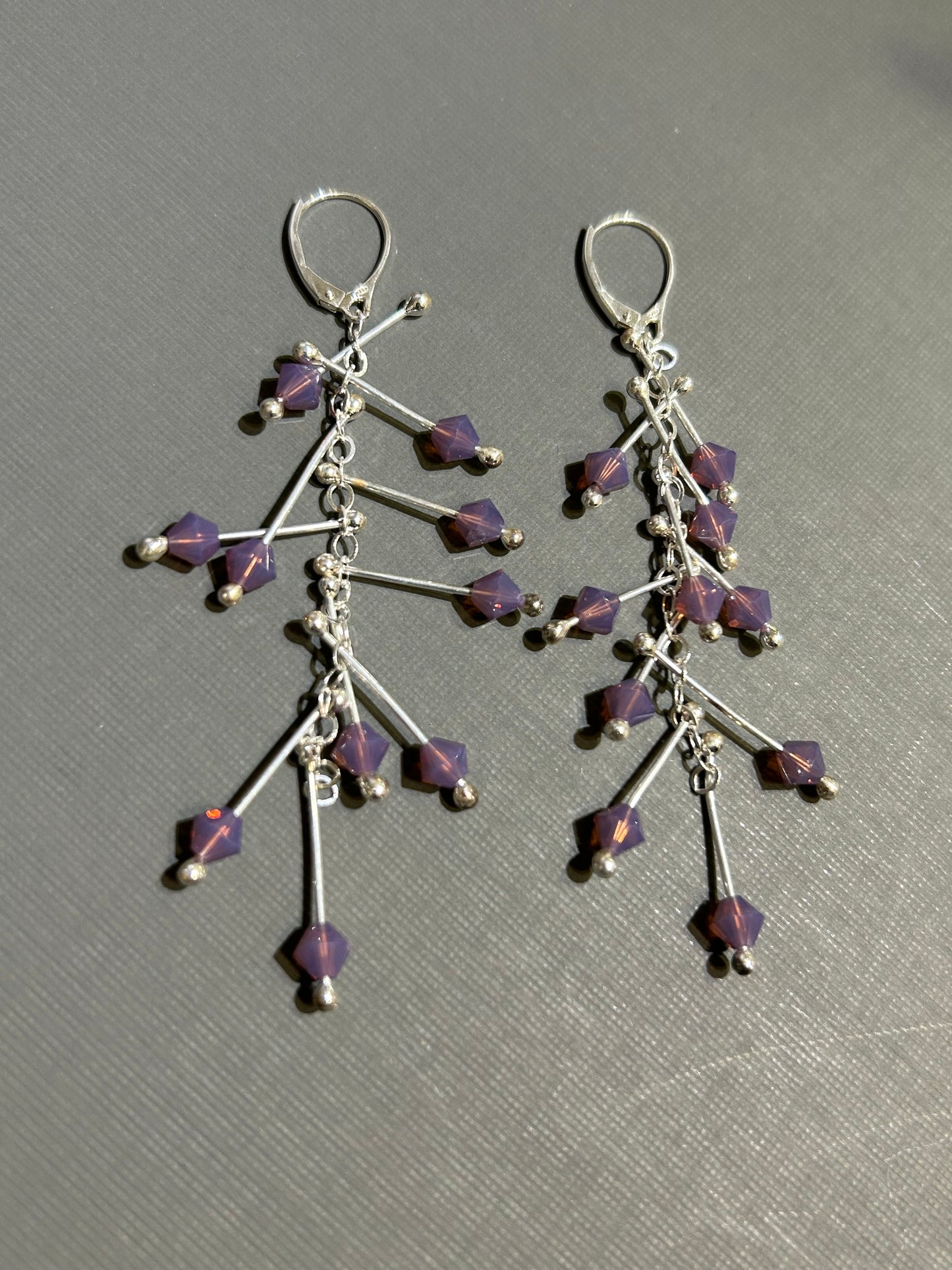 Kinetic earrings silver and purple crystals.