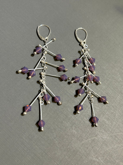 Kinetic earrings silver and purple crystals.