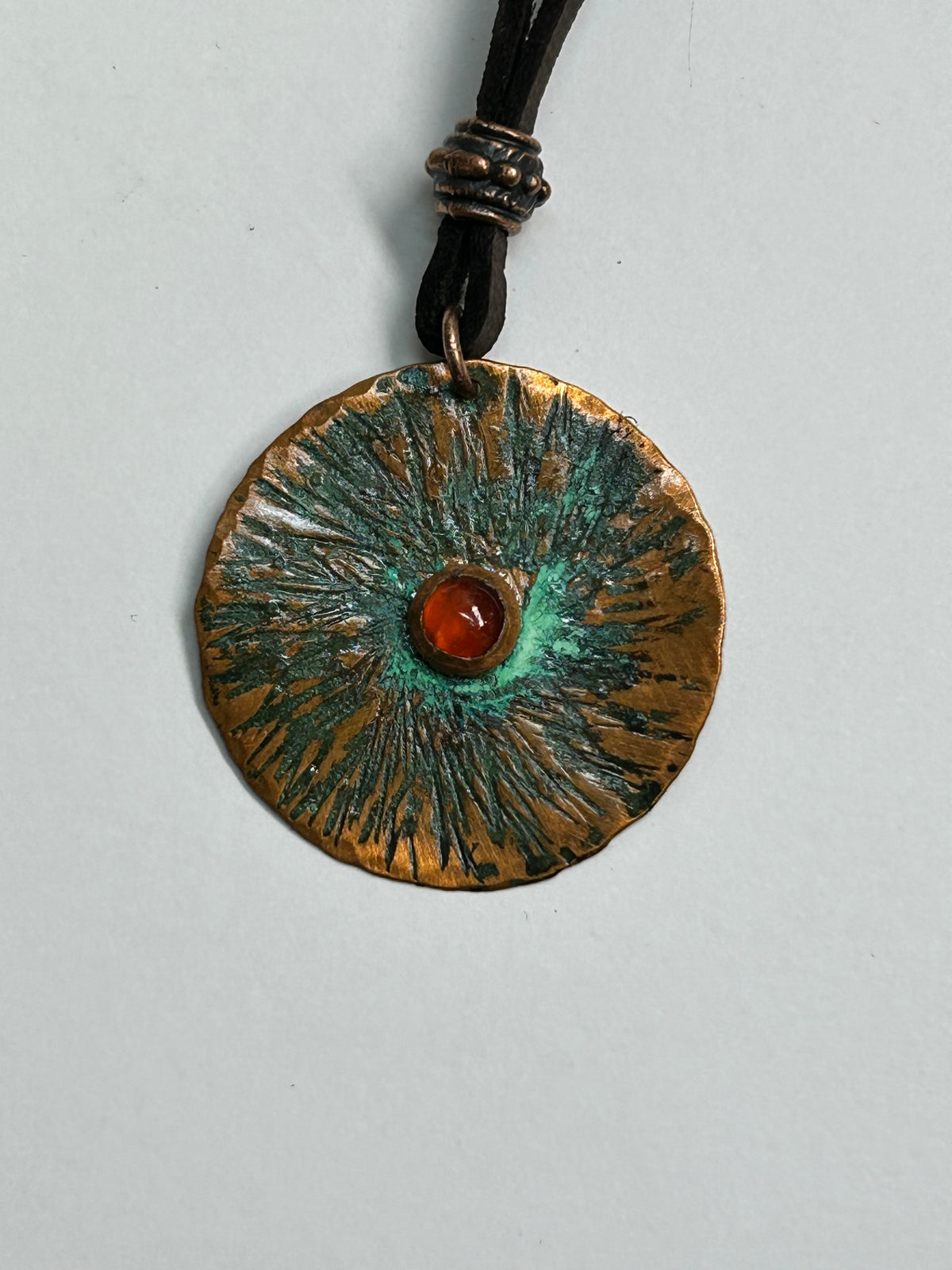 Copper  and carnelian pendant on leather