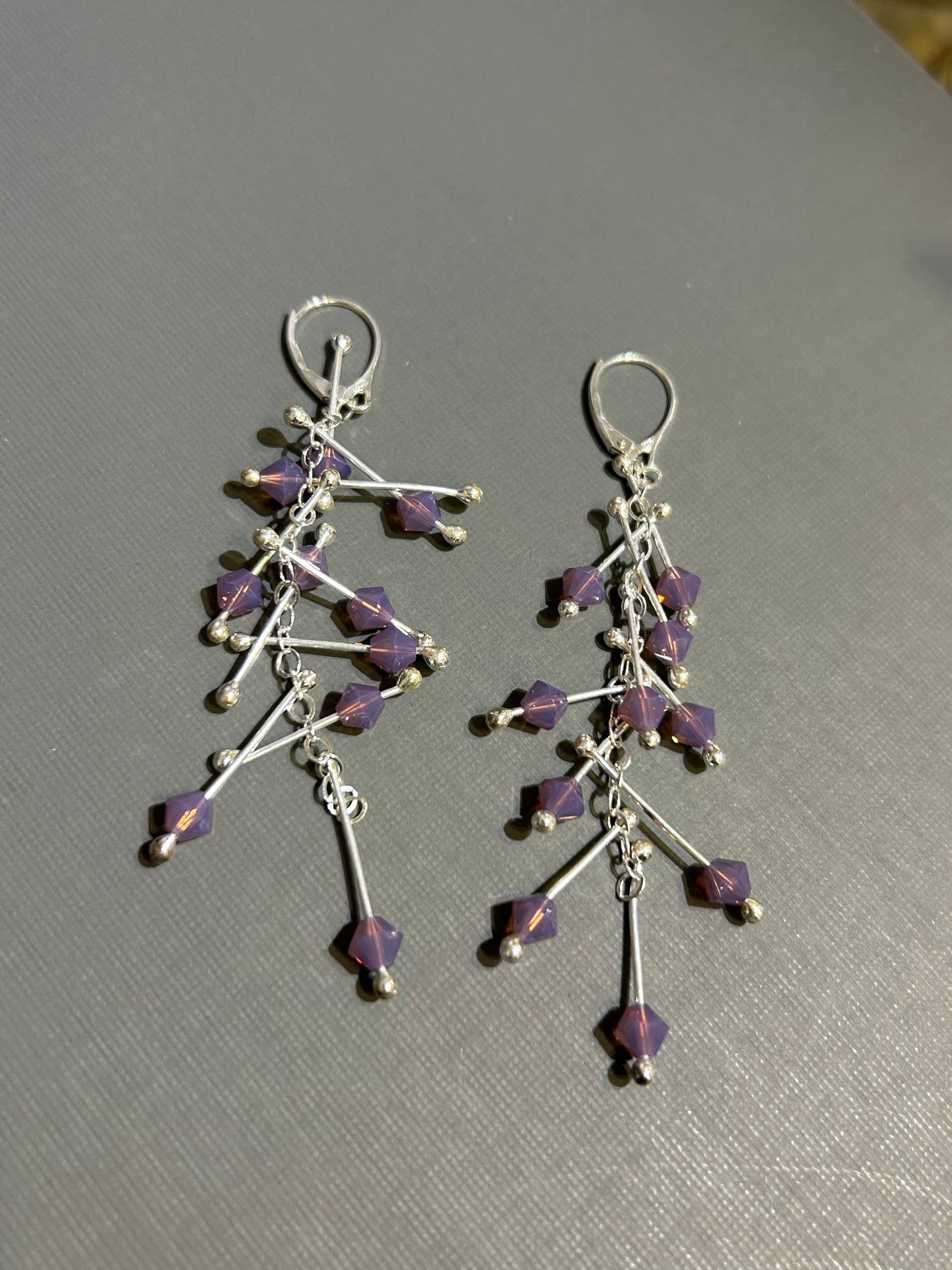Kinetic earrings silver and purple crystals.