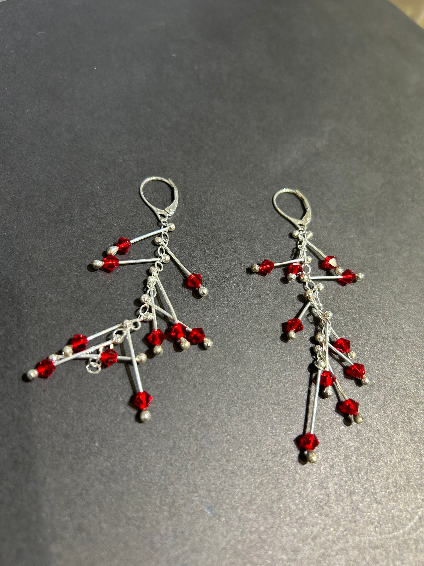 Kinetic earrings silver and red crystals
