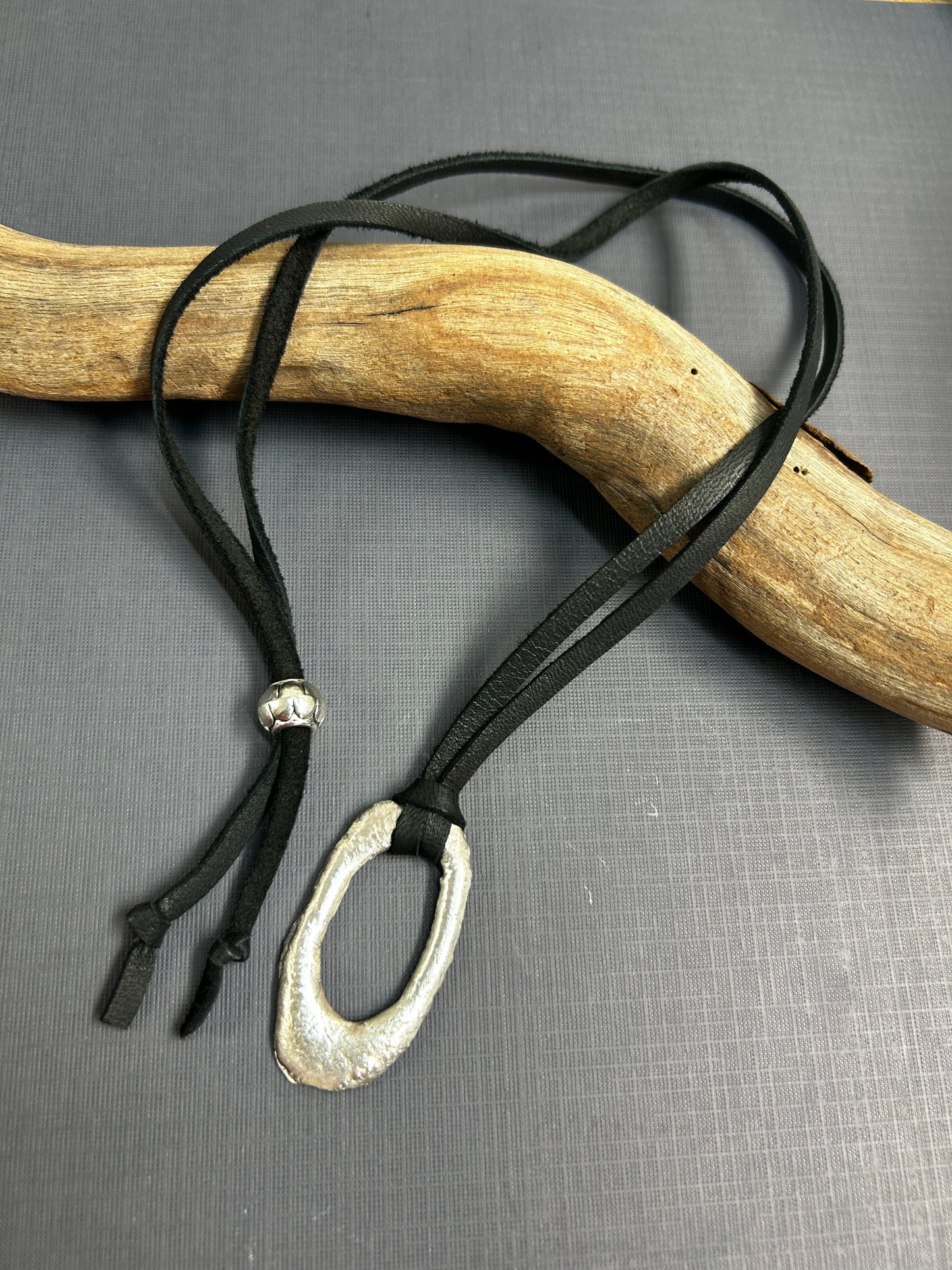 Recycled silver pendant on leather