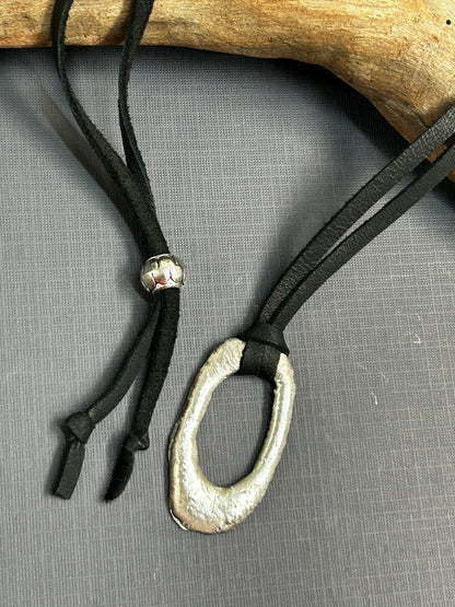 Recycled silver pendant on leather