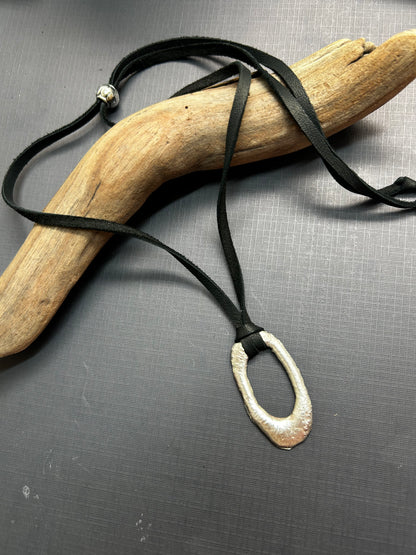 Recycled silver pendant on leather